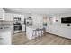 Bright kitchen featuring white cabinets, granite countertops, stainless steel appliances, and barstool seating at 238 Christiana Ln. # C, Myrtle Beach, SC 29579
