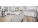 Well-lit kitchen boasts white cabinets, granite countertops, and an island perfect for cooking at 238 Christiana Ln. # C, Myrtle Beach, SC 29579