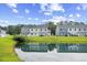 Scenic pond view reflecting the community's beautiful townhome exteriors at 238 Christiana Ln. # C, Myrtle Beach, SC 29579