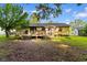 Backyard with a wooden deck, a grill, and mature trees providing ample shade at 238 Stonebrook Dr., Myrtle Beach, SC 29588