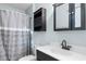 Bathroom featuring a shower with grey curtains, light countertop, and dark cabinets at 238 Stonebrook Dr., Myrtle Beach, SC 29588