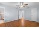 Bedroom with a ceiling fan, wood floor, access to a bathroom, and view into another bedroom at 238 Stonebrook Dr., Myrtle Beach, SC 29588
