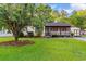 Charming home with a lush green lawn, mature tree, and screened-in porch at 238 Stonebrook Dr., Myrtle Beach, SC 29588