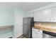Bright kitchen with stainless steel refrigerator, white cabinetry, stainless steel dishwasher and laminate countertops at 238 Stonebrook Dr., Myrtle Beach, SC 29588