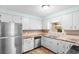Well-maintained kitchen featuring stainless-steel appliances, bright cabinets, and durable countertop at 238 Stonebrook Dr., Myrtle Beach, SC 29588