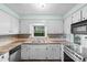 Traditional kitchen featuring white cabinets, double sink, light countertops, and stainless steel appliances at 238 Stonebrook Dr., Myrtle Beach, SC 29588
