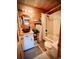 Cozy bathroom featuring wooden wall paneling, vessel sink and tub/shower combo with decorative shower curtain at 2419 Hilton Dr., North Myrtle Beach, SC 29582