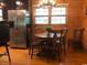 Dining area featuring a round table, wooden chairs, stainless steel fridge, and wood flooring at 2419 Hilton Dr., North Myrtle Beach, SC 29582