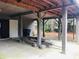 Ground level parking area with support beams, showing a trash can and doorway at 2419 Hilton Dr., North Myrtle Beach, SC 29582