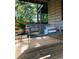 Inviting porch swing with accent pillows and a small side table offers a relaxing outdoor space at 2419 Hilton Dr., North Myrtle Beach, SC 29582