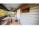 Cozy porch with dining table and chairs, plus a sign that says 'Welcome to Rustic Beach Lodge' at 2419 Hilton Dr., North Myrtle Beach, SC 29582
