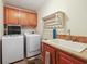 Functional laundry room with ample cabinet space, a utility sink, and modern washer and dryer at 263 Walden Lake Rd., Conway, SC 29526