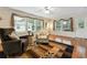 Cozy living room featuring wood-look floors, a ceiling fan, and natural light from large windows at 263 Walden Lake Rd., Conway, SC 29526