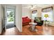 Open-concept living room with a view of the front yard, hardwood floors, and cozy decor at 263 Walden Lake Rd., Conway, SC 29526