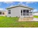 The rear of this house showcases a screened porch and concrete patio at 263 Walden Lake Rd., Conway, SC 29526