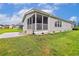 Rear exterior featuring a screened porch and concrete patio area at 263 Walden Lake Rd., Conway, SC 29526