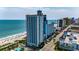Stunning aerial view of an oceanfront resort featuring pools, beaches, and ample parking at 3000 N Ocean Blvd. # 1406, Myrtle Beach, SC 29572