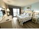 Relaxing bedroom featuring a queen bed, balcony access with ocean views, and coastal-themed decor at 3000 N Ocean Blvd. # 1406, Myrtle Beach, SC 29572