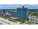 Expansive view of a beachfront condo building with palm trees and a large pool at 3000 N Ocean Blvd. # 1406, Myrtle Beach, SC 29572