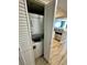 Convenient laundry closet featuring a stackable washer and dryer next to kitchen area at 3000 N Ocean Blvd. # 1406, Myrtle Beach, SC 29572