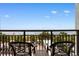 Charming balcony featuring chairs with ocean views, palm trees and beach at 3000 N Ocean Blvd. # 333, Myrtle Beach, SC 29577