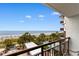 Relaxing balcony offers scenic ocean views, palm trees, pool, and outside dining at 3000 N Ocean Blvd. # 333, Myrtle Beach, SC 29577