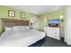 Comfortable bedroom with queen bed, dresser, television, and beach themed art at 3000 N Ocean Blvd. # 333, Myrtle Beach, SC 29577