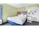 Cozy bedroom featuring a queen bed, bright blue accents and bedside table at 3000 N Ocean Blvd. # 333, Myrtle Beach, SC 29577