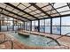 Relaxing indoor pool and hot tub area with a partial glass ceiling and walls allowing natural light to illuminate the space at 3000 N Ocean Blvd. # 333, Myrtle Beach, SC 29577
