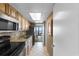 Galley kitchen with stainless steel sink, black appliances, and tile flooring at 3000 N Ocean Blvd. # 333, Myrtle Beach, SC 29577