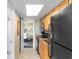 Kitchen with black appliances next to doorway revealing a neatly furnished bedroom at 3000 N Ocean Blvd. # 333, Myrtle Beach, SC 29577