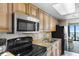 Bright kitchen with black appliances and backsplash near dining area and window at 3000 N Ocean Blvd. # 333, Myrtle Beach, SC 29577