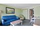 Relaxing living room with a blue sofa, green chair, table, and open doorway to the bedroom at 3000 N Ocean Blvd. # 333, Myrtle Beach, SC 29577