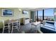 Lovely living room with balcony access, a television, a dresser, and a comfortable blue sofa at 3000 N Ocean Blvd. # 333, Myrtle Beach, SC 29577