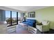 A relaxing living room with an ocean view, blue sofa, and comfortable chairs at 3000 N Ocean Blvd. # 333, Myrtle Beach, SC 29577