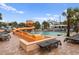 Outdoor pool area with a large winding water slide, lounge chairs, and tables in a beautiful tropical setting at 3000 N Ocean Blvd. # 333, Myrtle Beach, SC 29577