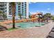 Outdoor pool with water slides, palm trees, and inviting clear water at 3000 N Ocean Blvd. # 333, Myrtle Beach, SC 29577