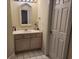 Bathroom with a decorative mirror and white tiled floors at 330 S Middleton Dr. # 603, Calabash, NC 28467