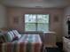 Bright bedroom with colorful bedding, window view, and ample space at 330 S Middleton Dr. # 603, Calabash, NC 28467