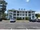 Exterior view of a three-story building with parking and private balconies at 330 S Middleton Dr. # 603, Calabash, NC 28467