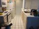 Galley kitchen featuring linoleum tile floor, white appliances, and breakfast bar at 330 S Middleton Dr. # 603, Calabash, NC 28467