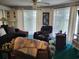 Living room featuring dark brown sectional, reclining chairs, ceiling fan, and bright natural light at 330 S Middleton Dr. # 603, Calabash, NC 28467