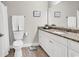 A full bathroom with white cabinetry, granite countertops, toilet and shower at 35 Delray Dr. # 3A, Murrells Inlet, SC 29576