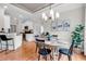 Dining area adjacent to a kitchen with a round table and bright chandelier at 35 Delray Dr. # 3A, Murrells Inlet, SC 29576