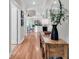 Bright hallway with hardwood floors provides a view of the open-concept kitchen and living areas at 35 Delray Dr. # 3A, Murrells Inlet, SC 29576