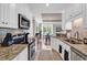 Kitchen leading to a dining area with wood floors and a window view at 35 Delray Dr. # 3A, Murrells Inlet, SC 29576