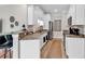 Bright kitchen featuring granite countertops, stainless steel appliances, breakfast bar, and ample white cabinetry at 35 Delray Dr. # 3A, Murrells Inlet, SC 29576