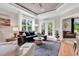 Comfortable living room with hardwood floors, bright windows, and access to the screened-in porch at 35 Delray Dr. # 3A, Murrells Inlet, SC 29576