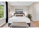 A well-lit main bedroom features a plush bed, decorative bench, and serene decor, creating a peaceful retreat at 35 Delray Dr. # 3A, Murrells Inlet, SC 29576