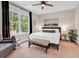 A well-lit main bedroom features a plush bed, decorative bench, seating area, and serene decor at 35 Delray Dr. # 3A, Murrells Inlet, SC 29576